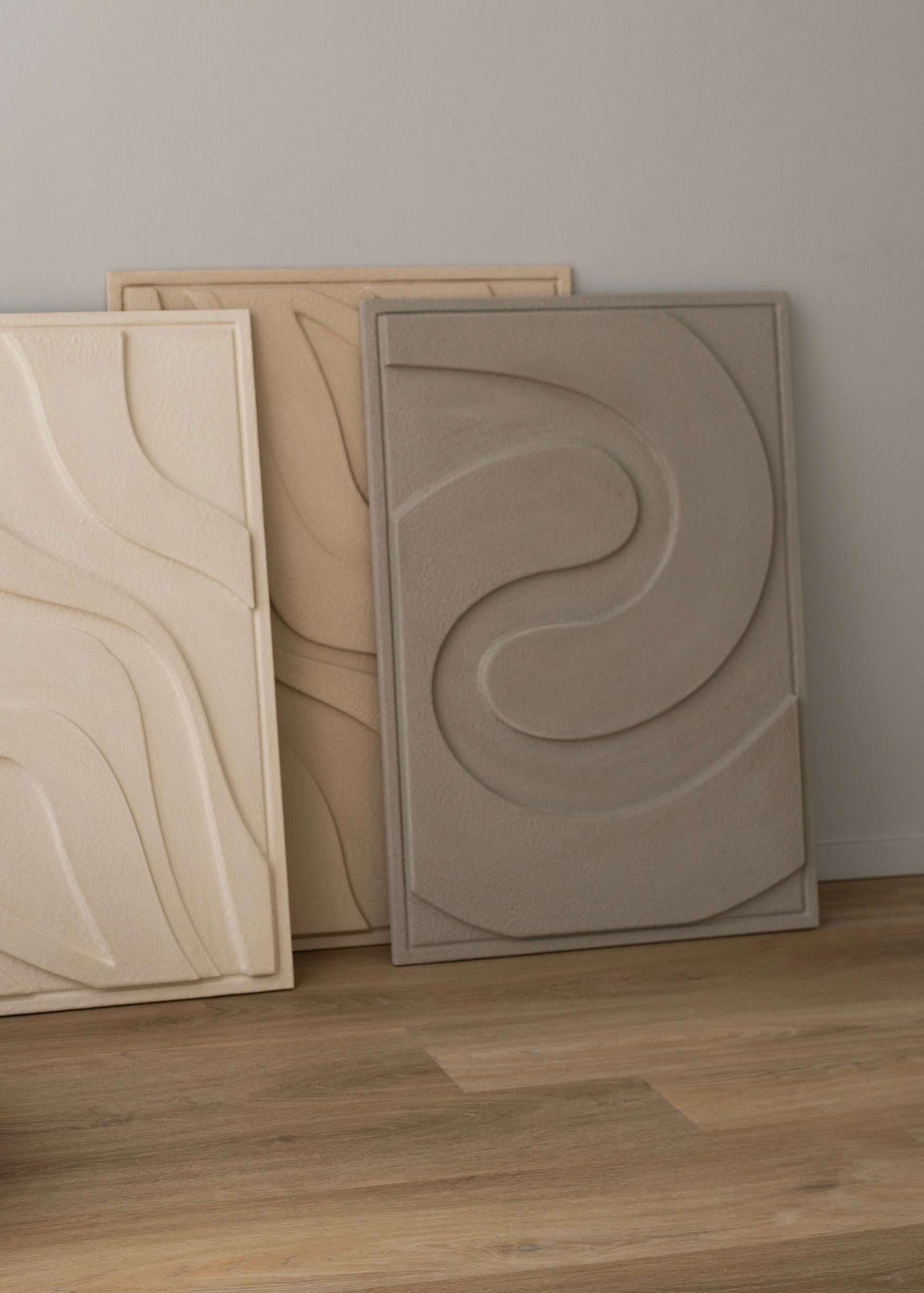 Sustainable AIR wall relief made from biodegradable clay plaster, showcasing soft, wind-like curves for an ethereal and eco-friendly addition to modern decor.